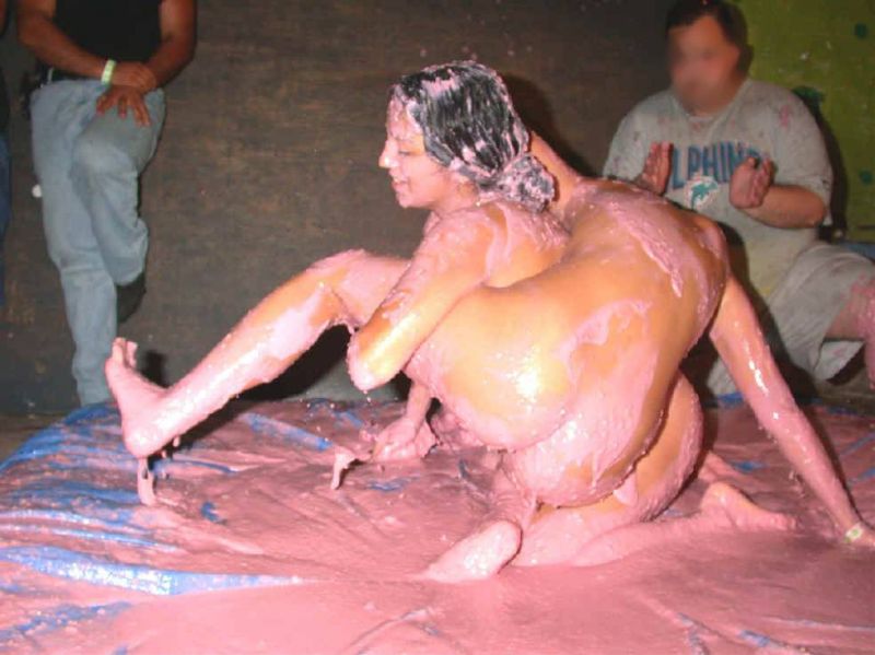 muscular women mud wrestling