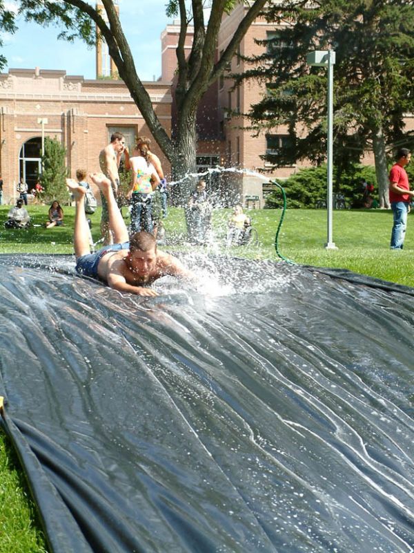man falls off water slide