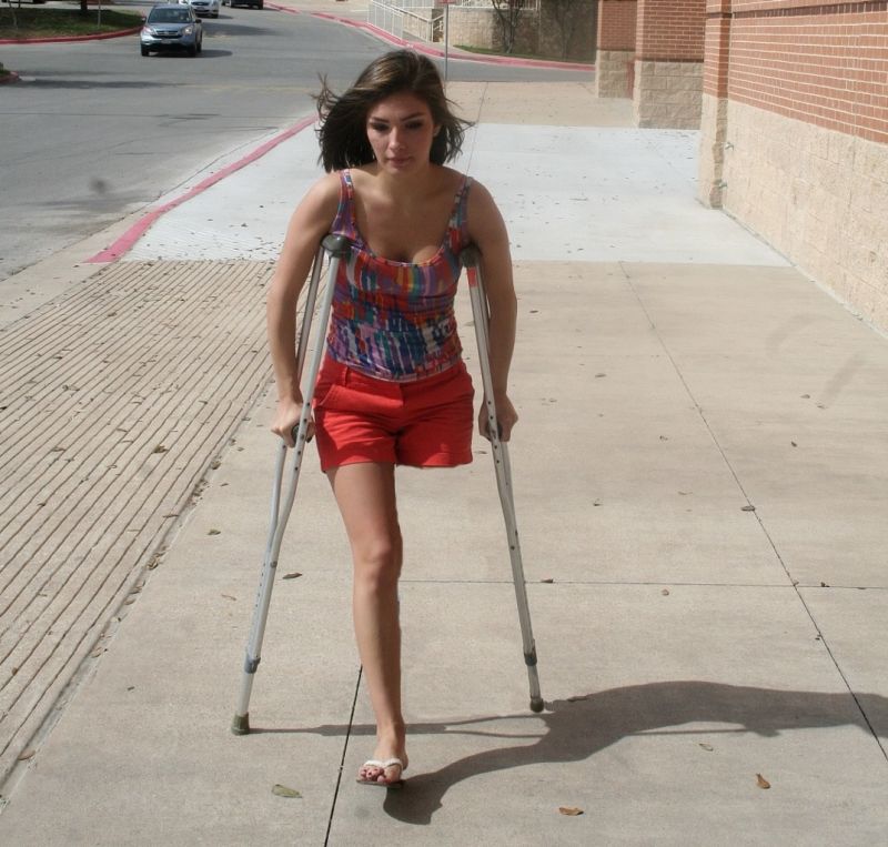 one legged woman walking with crutches