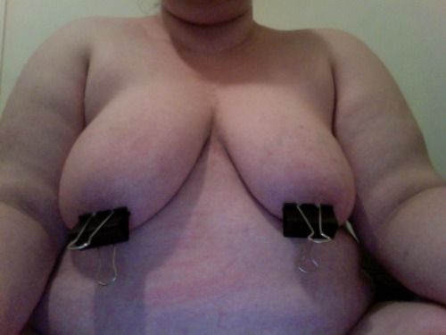 clothes pins on her nipples