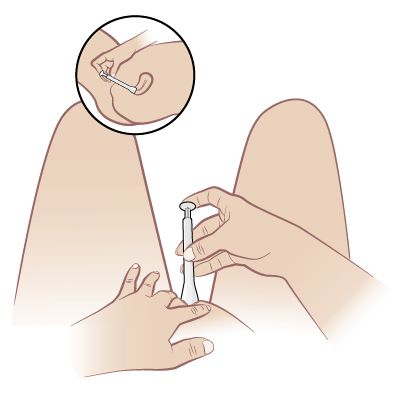 woman inserting suppository