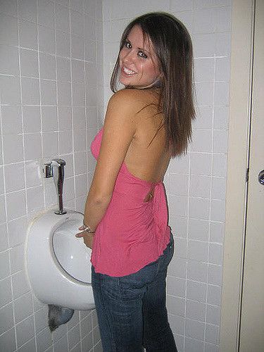 Nude women use urinal