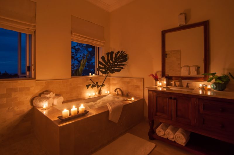 woman in bubble bath with candles