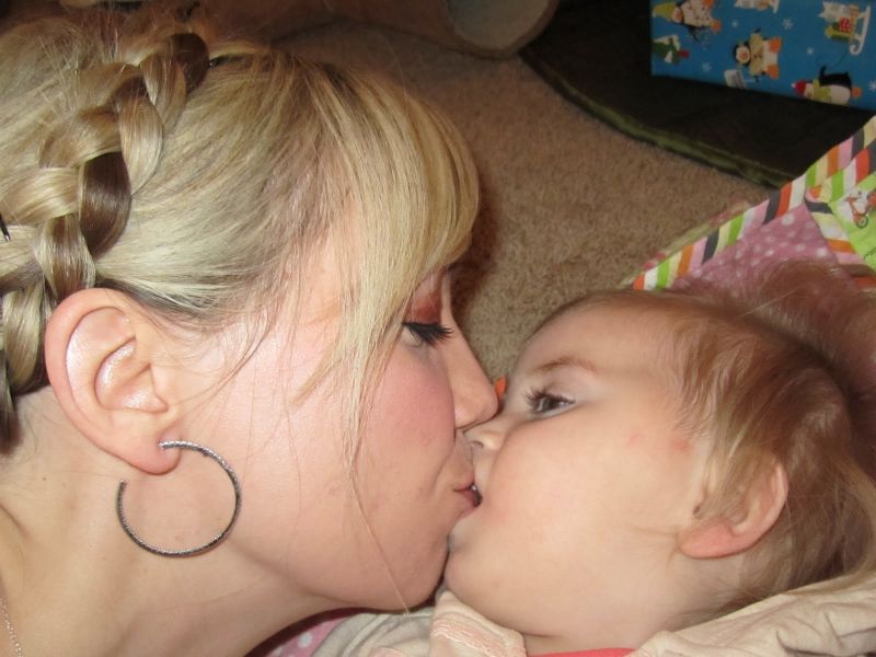 young mother and daughter kiss