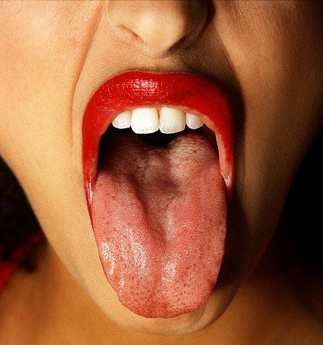 woman sticking out tongue seductive