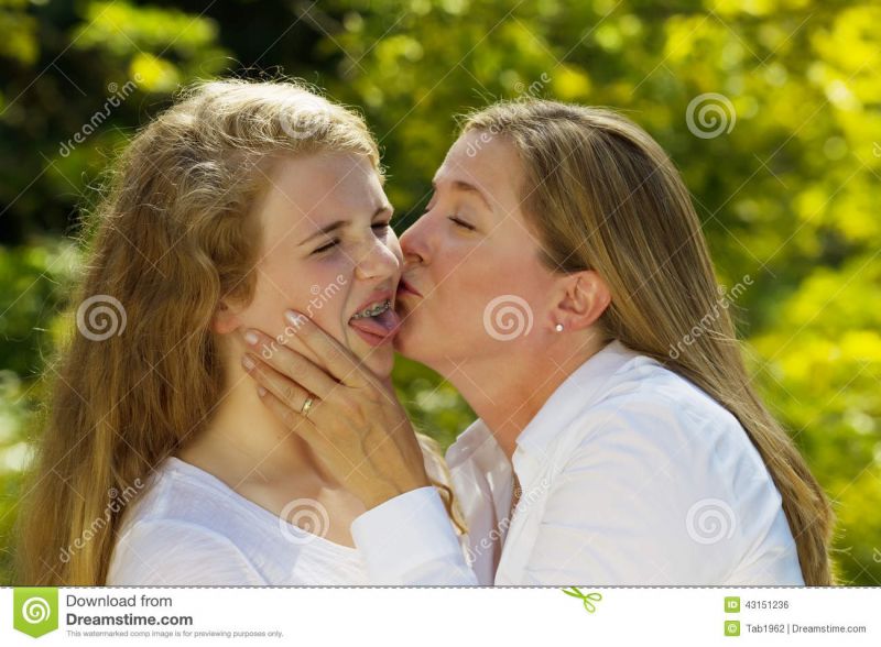 mom kissing daughter goodnight