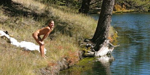 woman skinny dipping at waterfall