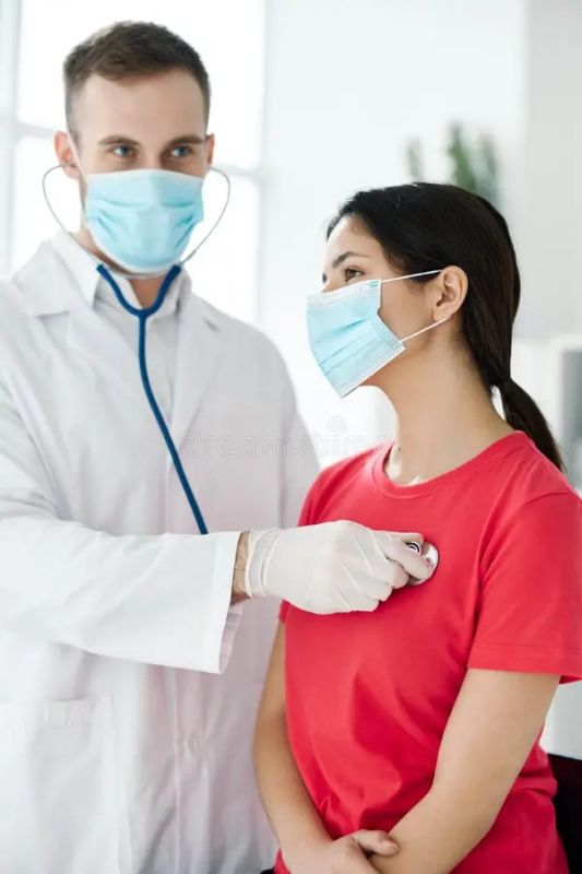 female doctors standing in exam room talking to pan