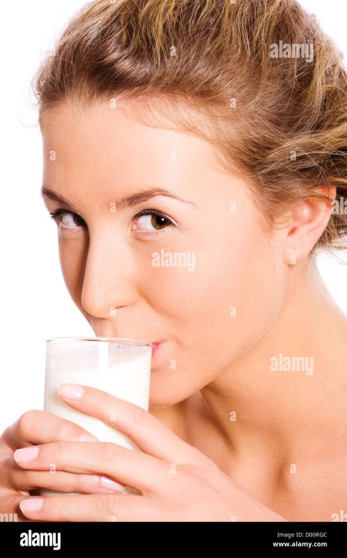 woman drinking milk out of bowl on ground